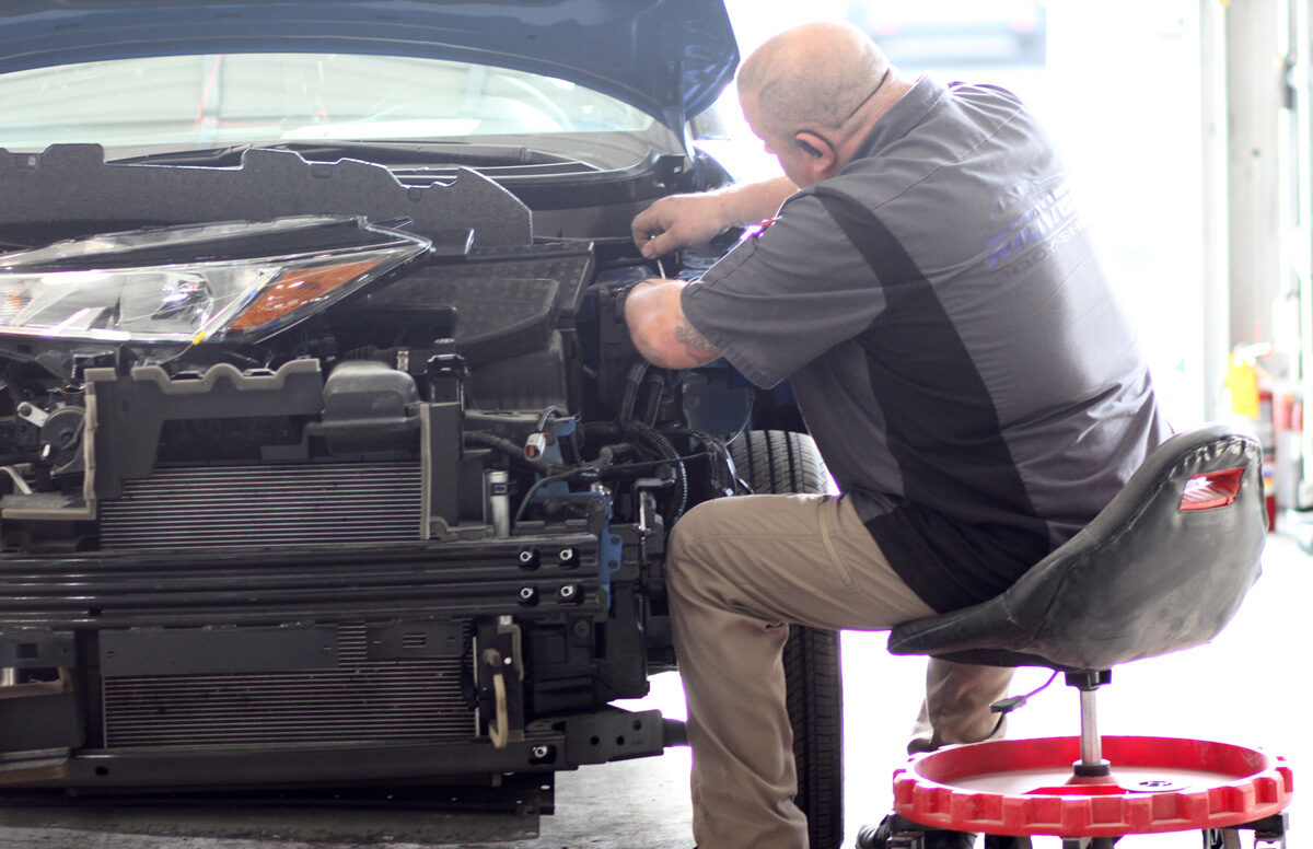 team member repairing a vehicle
